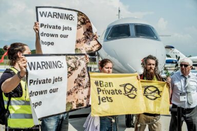 Activists, peacefully occupying, protest, private jets