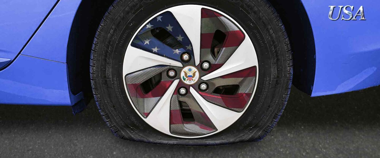 USA branded car, flat tire, American flag