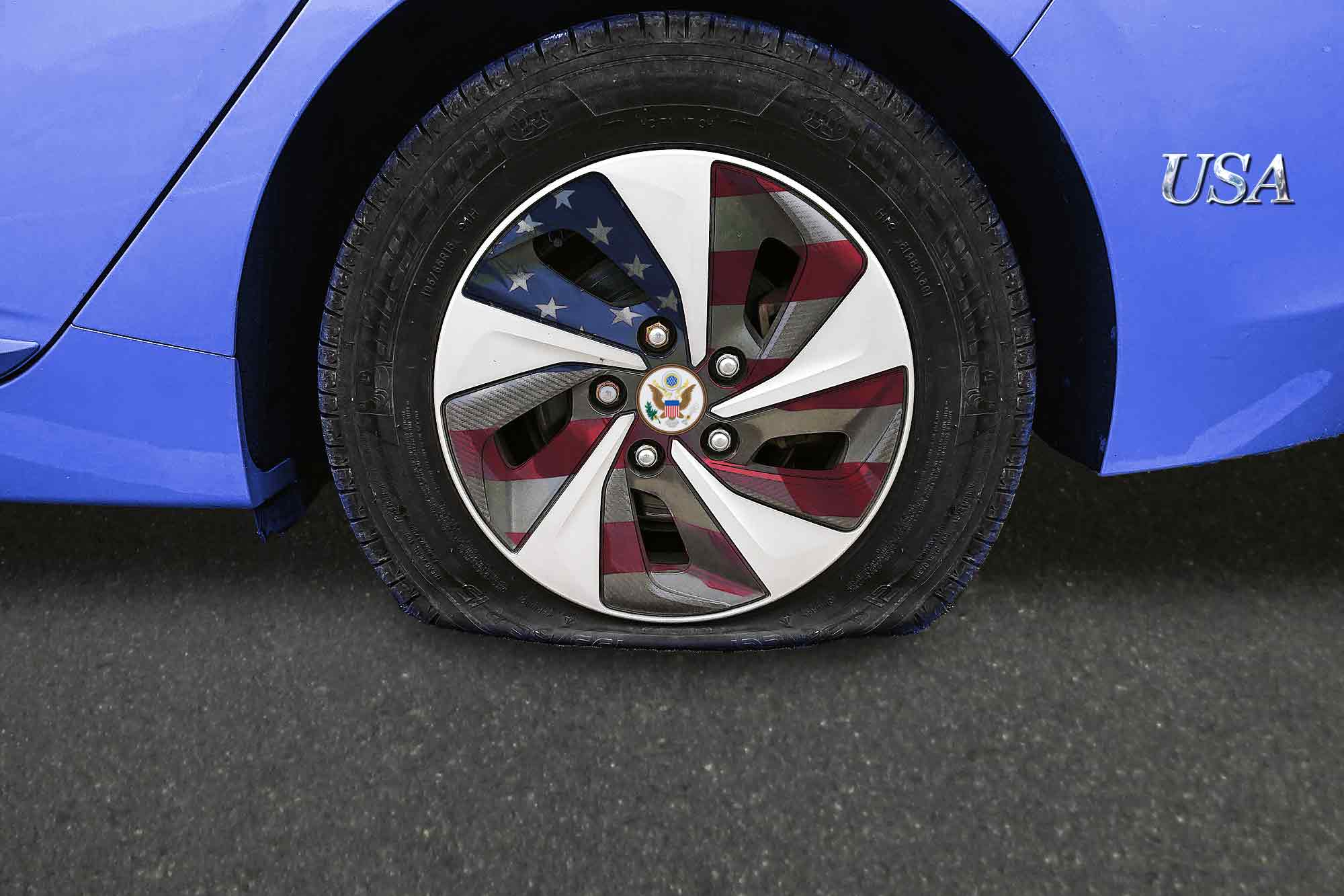 USA branded car, flat tire, American flag