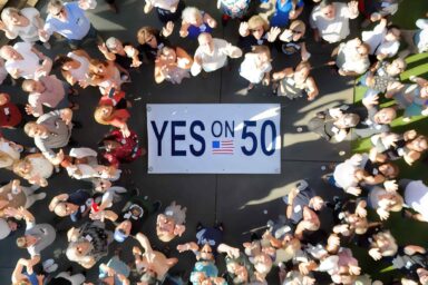 Yes on 50, sign, crowd