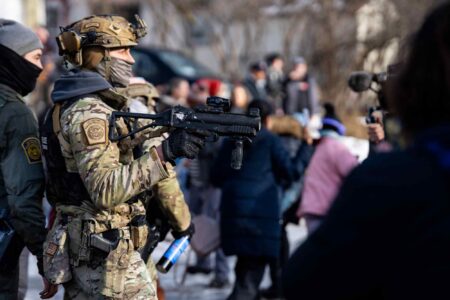 federal agent points weapon, less lethal, anti-ICE protesters